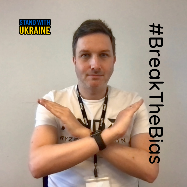 our director Niall O'Malley with crossed arms to signify 'breaking the bias' which is the theme for International Women's Day 2022