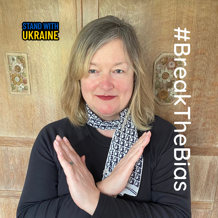 our director Jane Franklin with crossed arms to signify 'breaking the bias' which is the theme for International Women's Day 2022