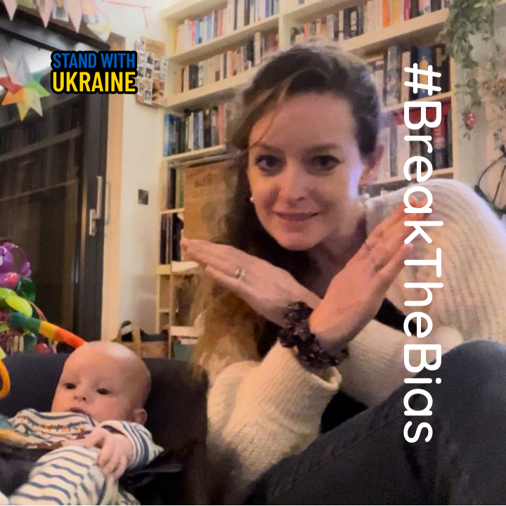 our director Sarah Bradbury and baby with crossed arms to signify 'breaking the bias' which is the theme for International Women's Day 2022